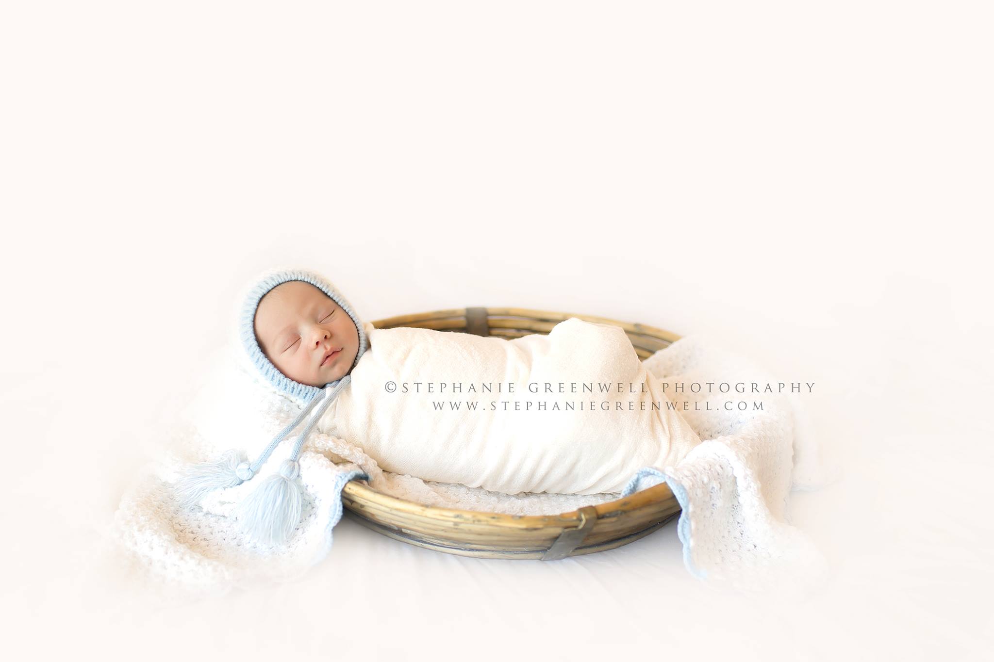 newborn baby boy swaddled white backdrop blanket basket bonnet blue stephanie greenwell southeast missouri newborn photographer