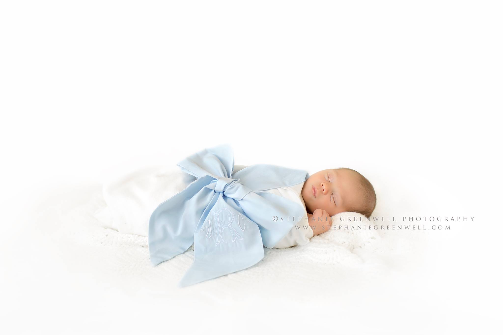 newborn baby boy monogrammed blue ribbon swaddle white backdrop blanket stephanie greenwell southeast missouri newborn photographer